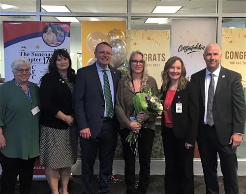Dr. Kristie Jo Redfering, flanked by Superintendent Kevin Hendrick, ESE Executive Director Lynne Mowatt and PCS staff